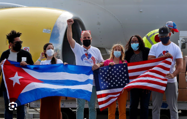 Manolo De Los Santos alongside Cuban President Díaz-Canel at Nuestra América convoy march, March 2026