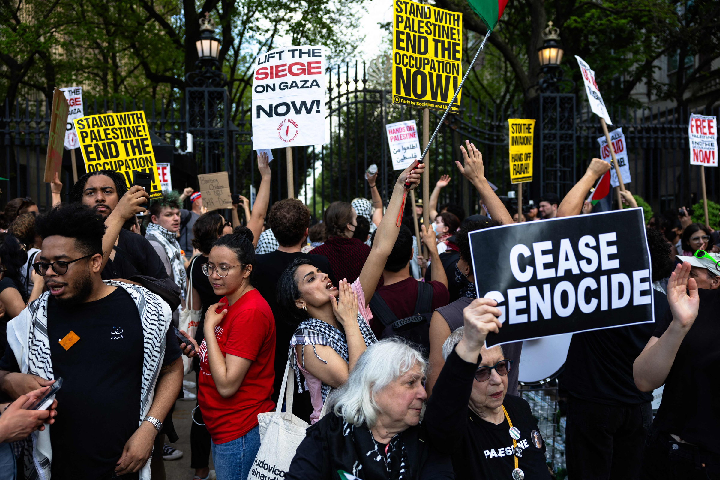 Columbia University gate demonstration April 30 2024 — Manolo De Los Santos circled in red, CEASE GENOCIDE sign